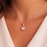 Necklace with a pink pendant worn by a person