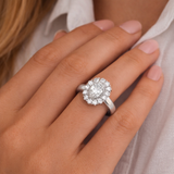 Silver ring with a halo diamond on a person's finger