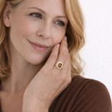 Woman wearing a ring with a halo design on a white background